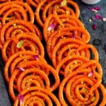 Hot, crunchy and sweet instant jalebi topped with crushed pistachios and rose petals.