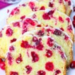 Fresh Cranberry Bread recipe topped with orange glaze served on a white platter.