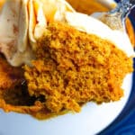 Pumpkin mug cake made in a microwave topped with cinnamon frosting.