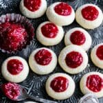 Soft and buttery Raspberry Thumbprint Cookies sprinkled with confectioners' sugar.
