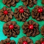 Chocolate butter cookies made with simple ingredients and topped with candied cherries