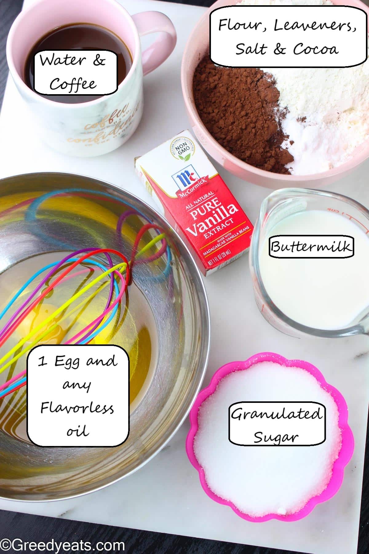Ingredients like oil, sugar, cocoa, flour, baking powder and baking soda to make chocolate cake batter.