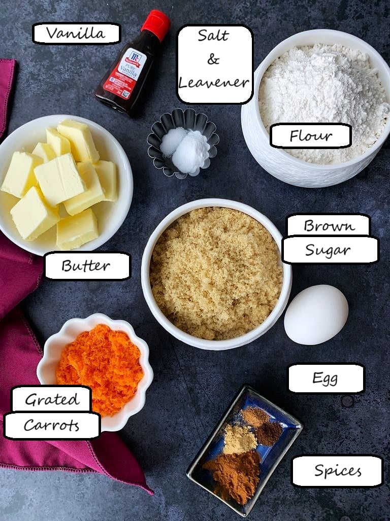 Ingredients like flour, carrots, brown sugar, spices and leaveners for carrot cookies. 