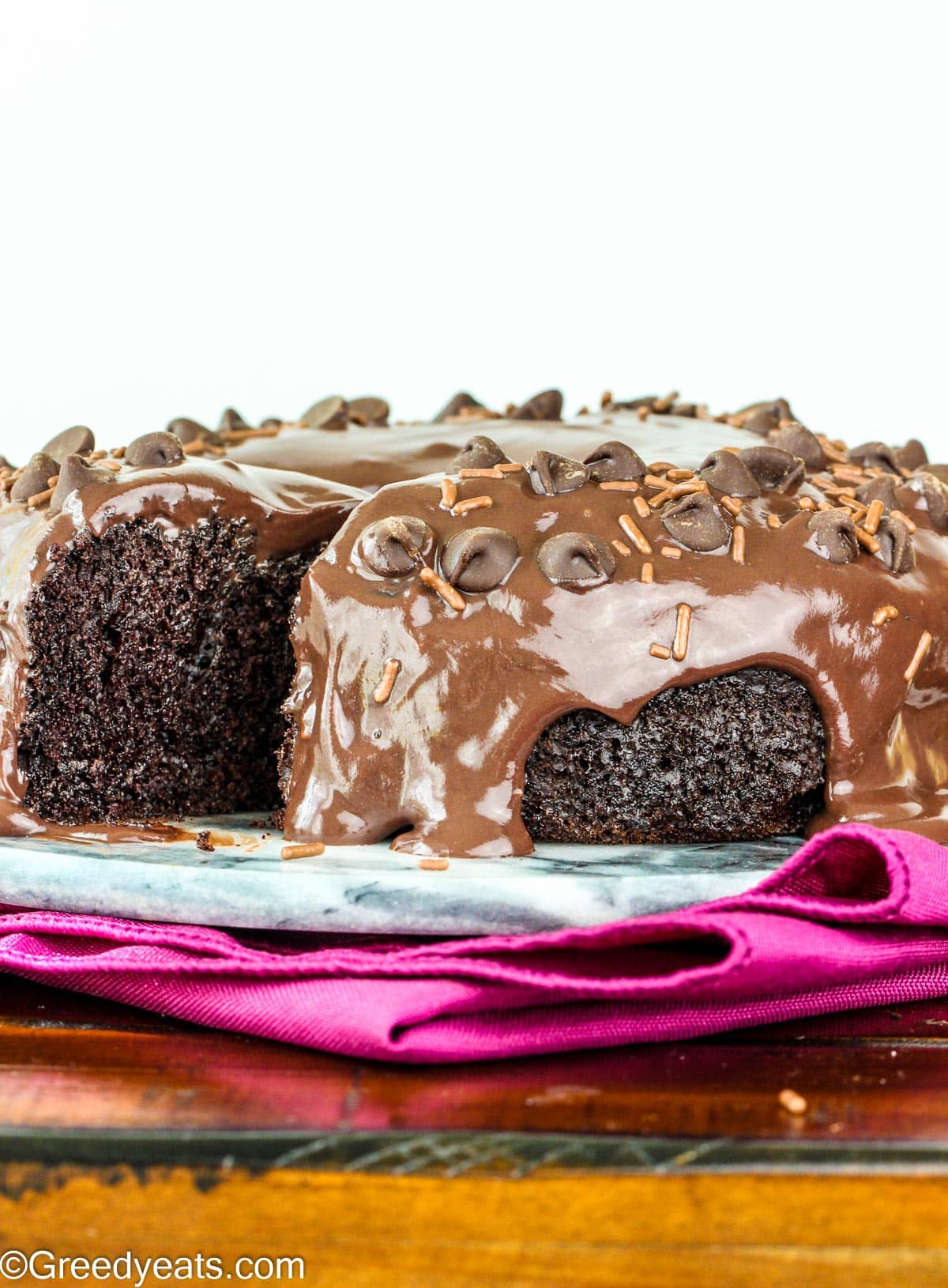 easy and simple Chocolate Cake recipe drizzled with chocolate ganache.