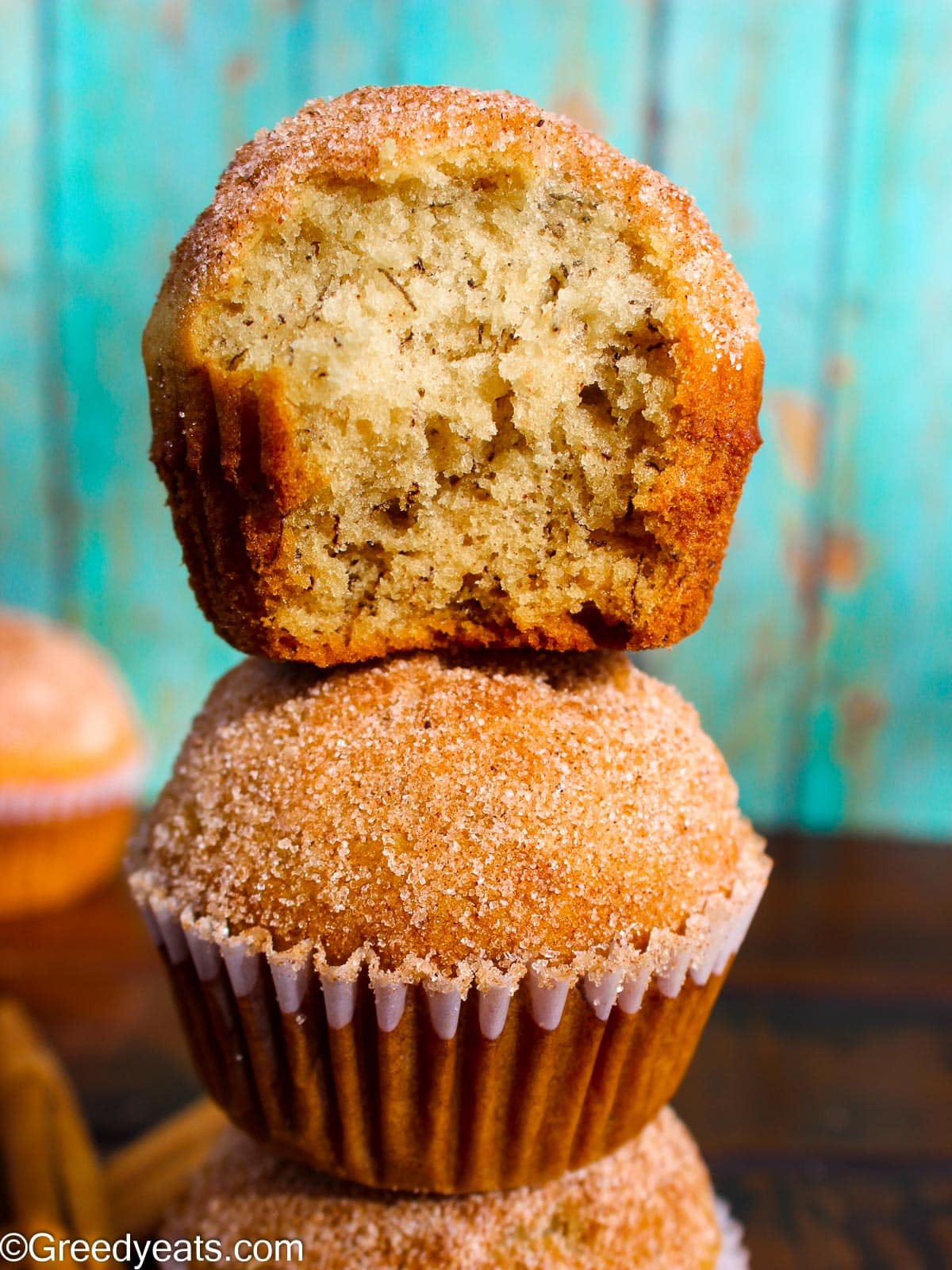 A stack of soft, fluffy Banana Muffins 2 Bananas with cinnamon sugar topping.