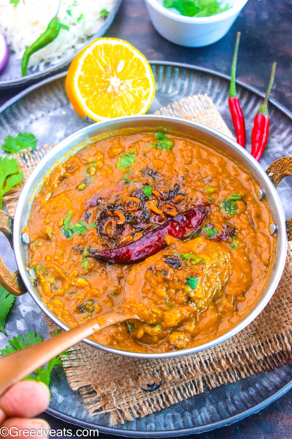 Dal fry recipe made with Indian herbs, aromatics and spices served in a bowl.