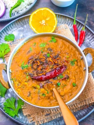 Easy Dal Fry Recipe made with toor dal, a little moong dal, aromatics and spices served with lemon and coriander.