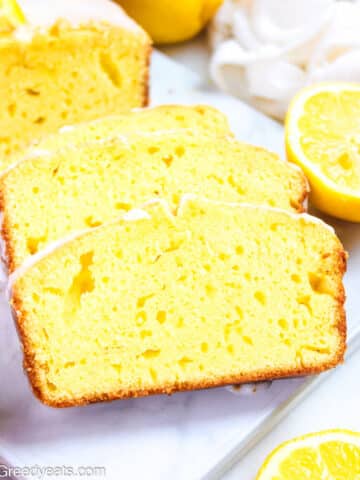 Easy Lemon Yogurt Cake topped with lemon glaze and fresh lemon slices.