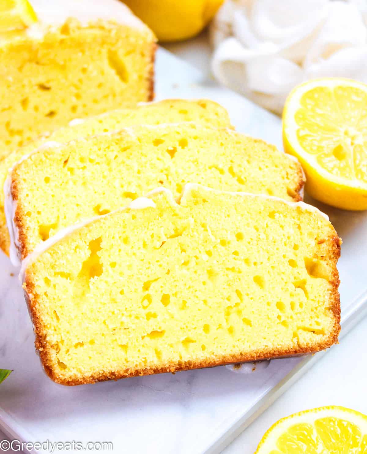 Easy Lemon Yogurt Cake topped with lemon glaze and fresh lemon slices.