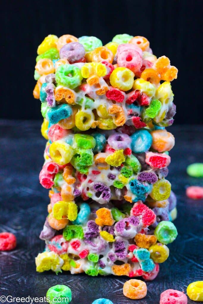 A stack of Froot Loops Bars made with three simple ingredients- butter, melted marshmallows and cereal.