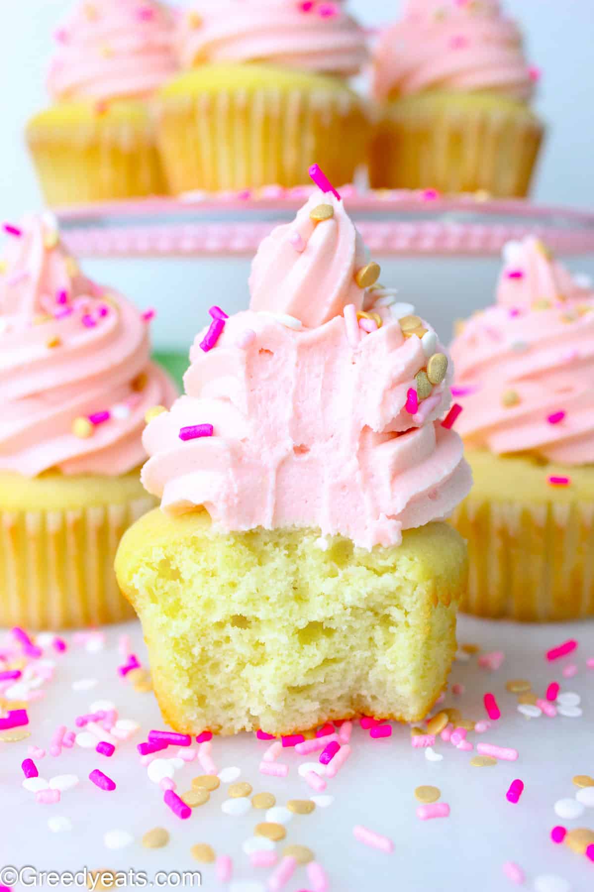Soft, fluffy and moist Vanilla Cupcakes Recipe topped with a silky vanilla buttercream and sprinkles.